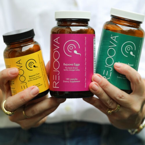 Woman holding Rejoova Core, Rejoova Eggs, and Rejoova Repair fertility supplements